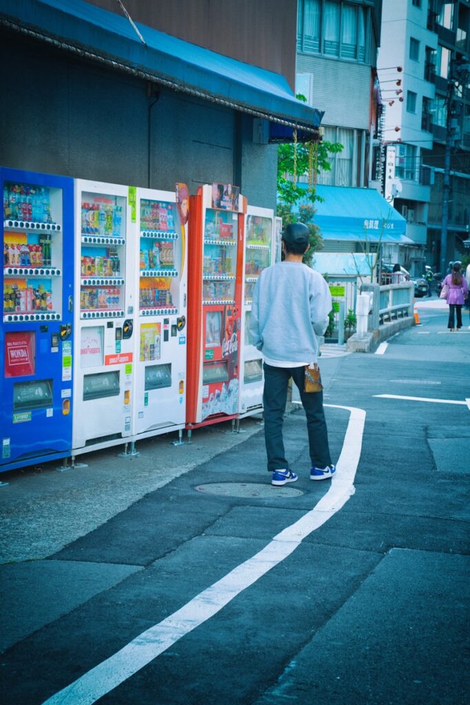 a man standing in front of a vending machine