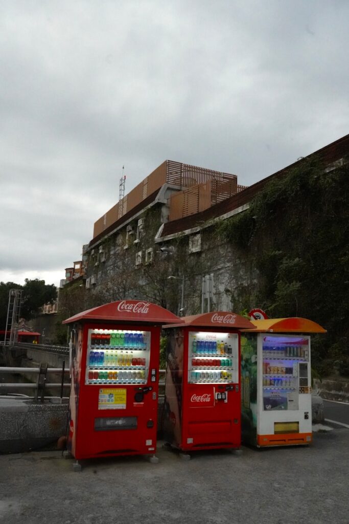 Three coca-cola vending machines in a row.