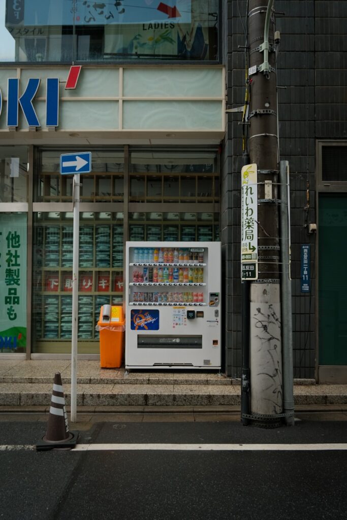A vending machine sits on a city sidewalk.